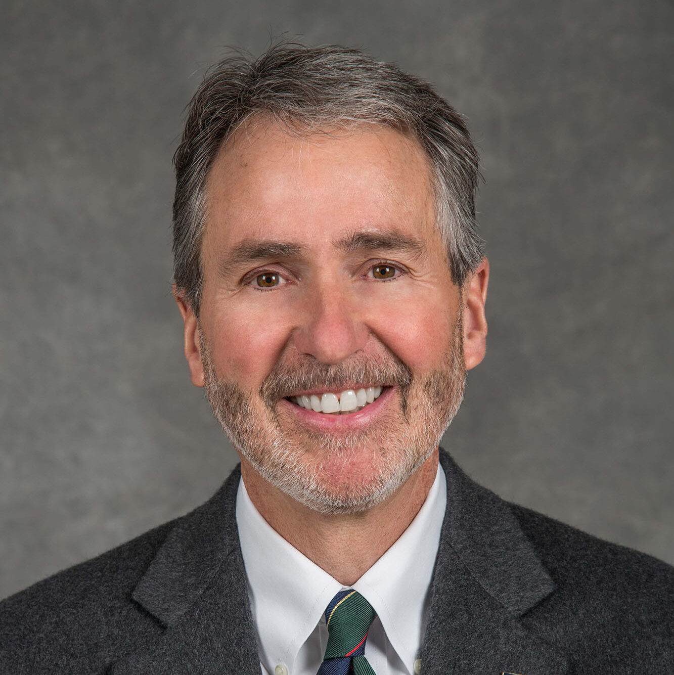 Michael Brandt, a light-haired person wearing a gray suit and tie.