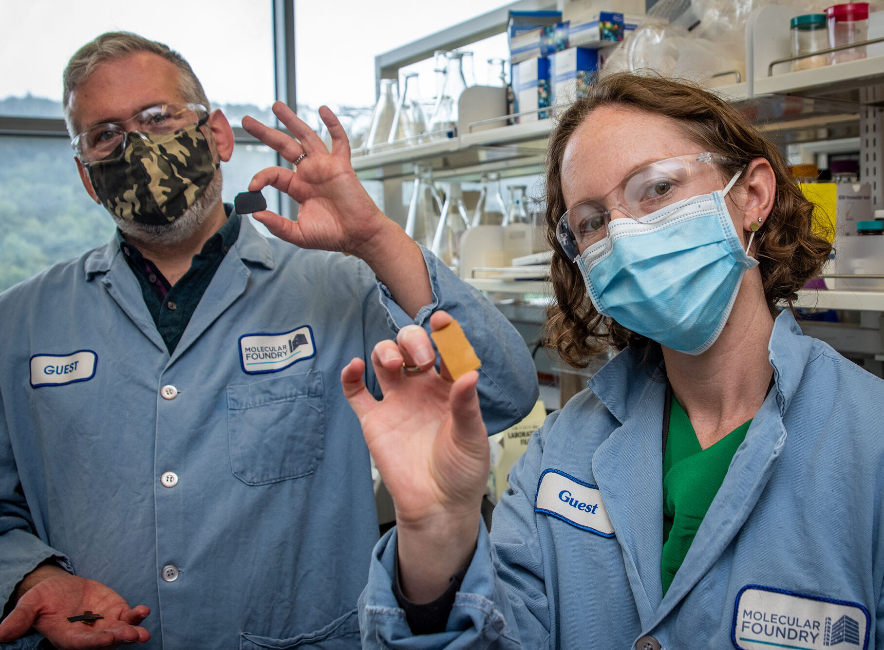 Two scientists holding samples of PDK plastic.