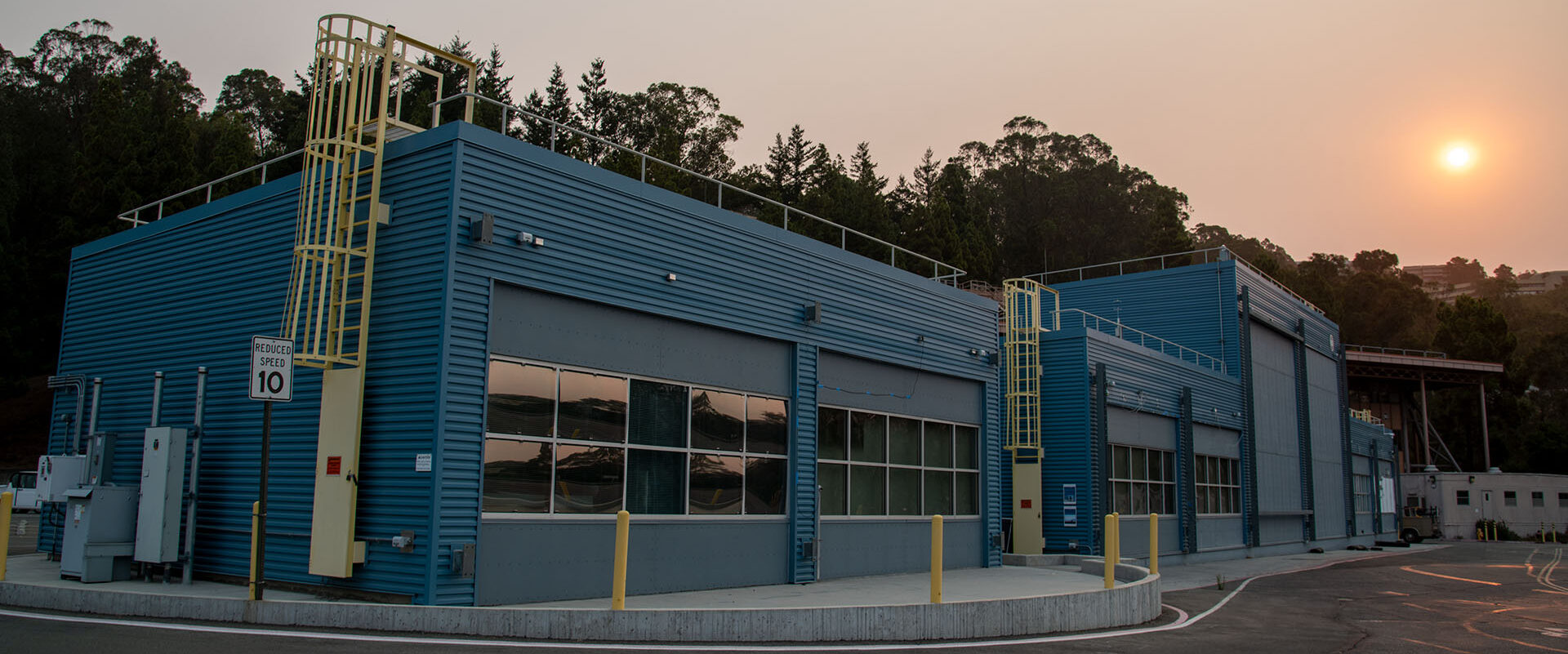 The sun is obscured behind smokey skies over FLEXLAB™ at Lawrence Berkeley National Laboratory.