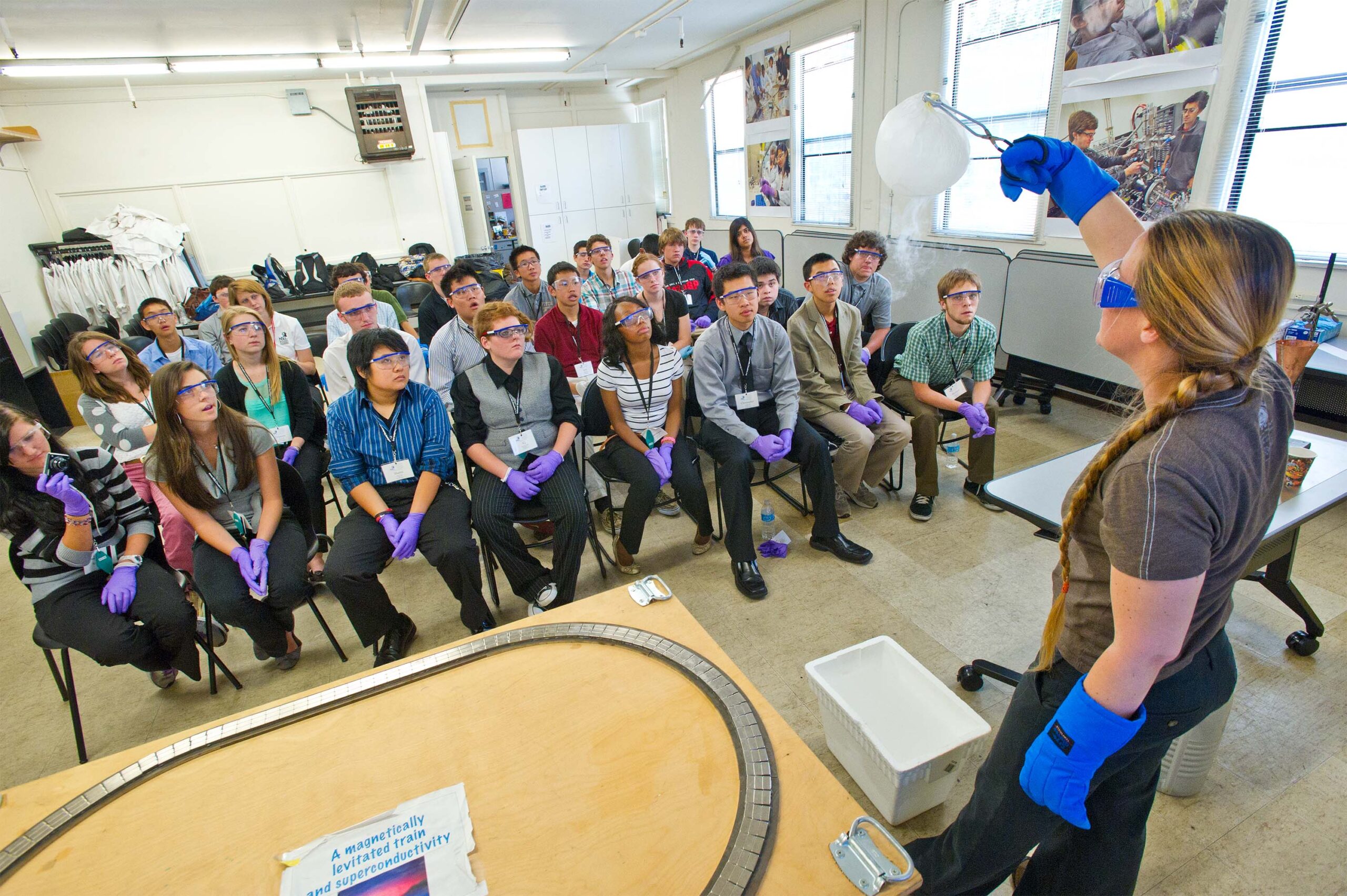 Scientist presents science activities to high school students.