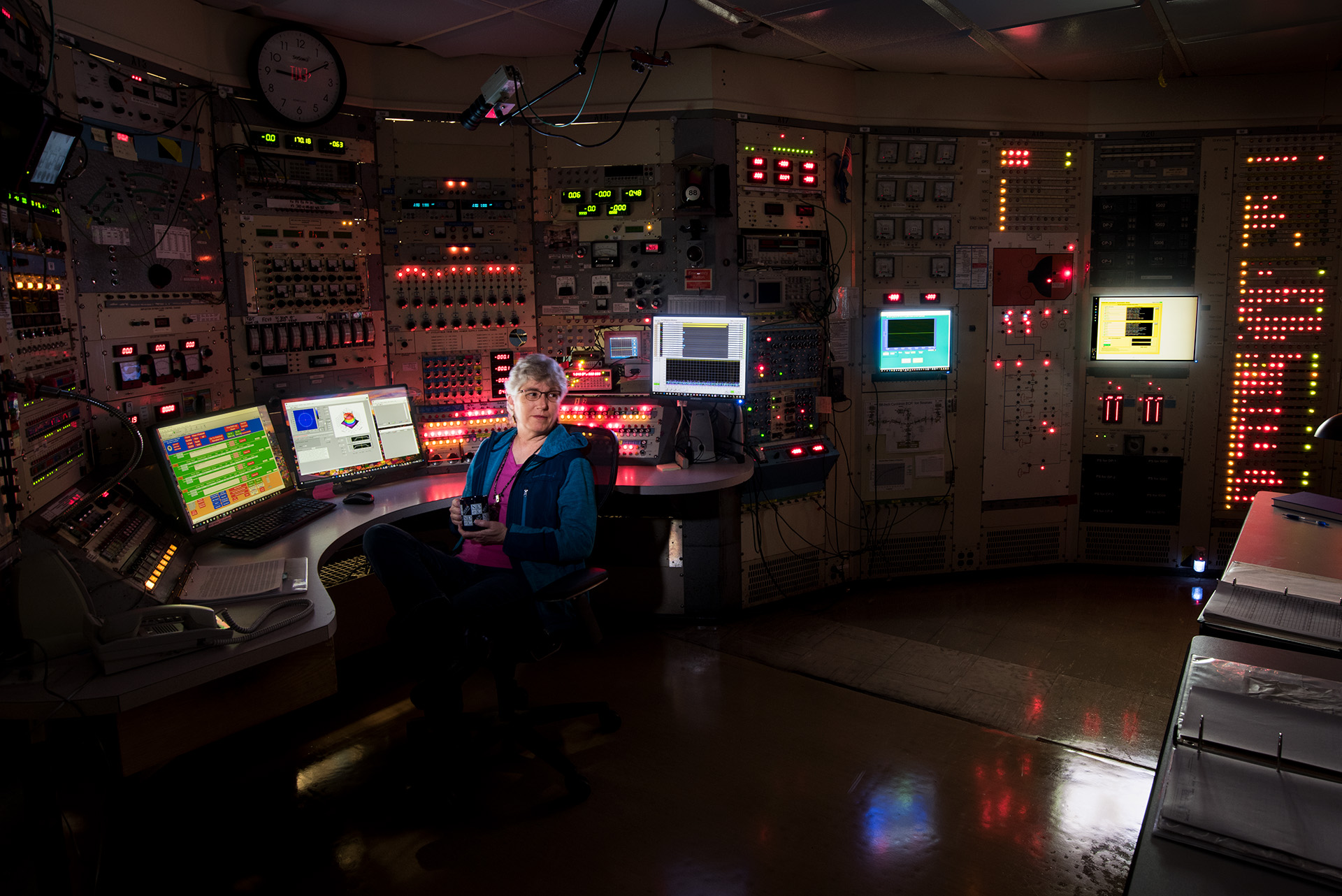Scientist in a glowing control room.