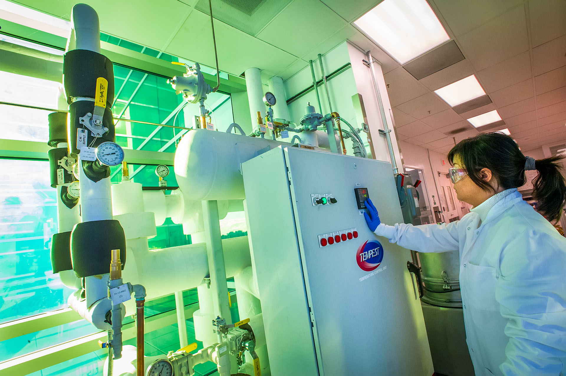 Scientist working at a biofuels processing building.