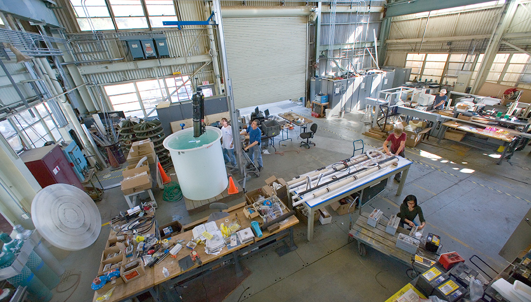 Many piece of large scientific instrumentation in a large bay holding facility.