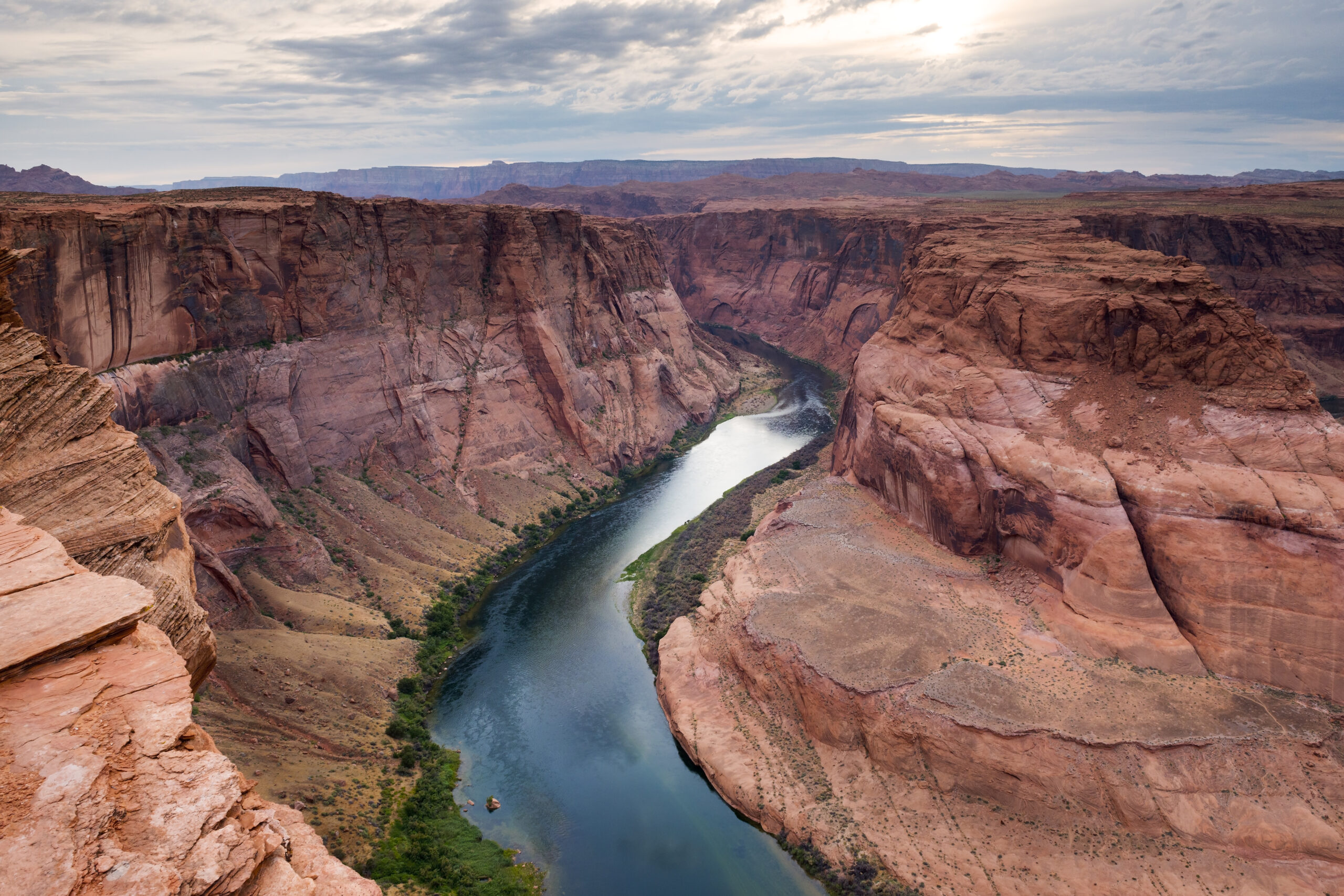 Brown canyon with river running down the middle.