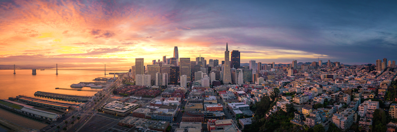 Panoramic view of San Francisco skyline at sunrise.