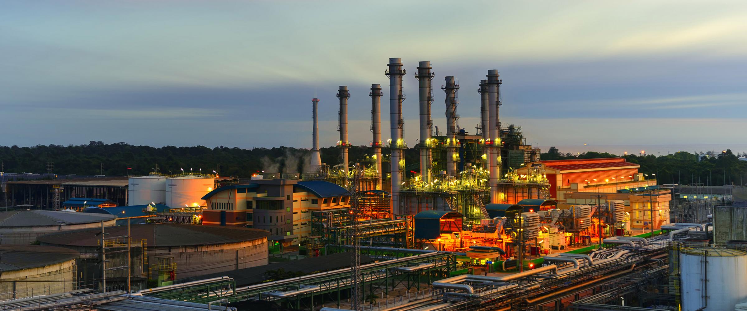 Exterior view of a factory at sunset.