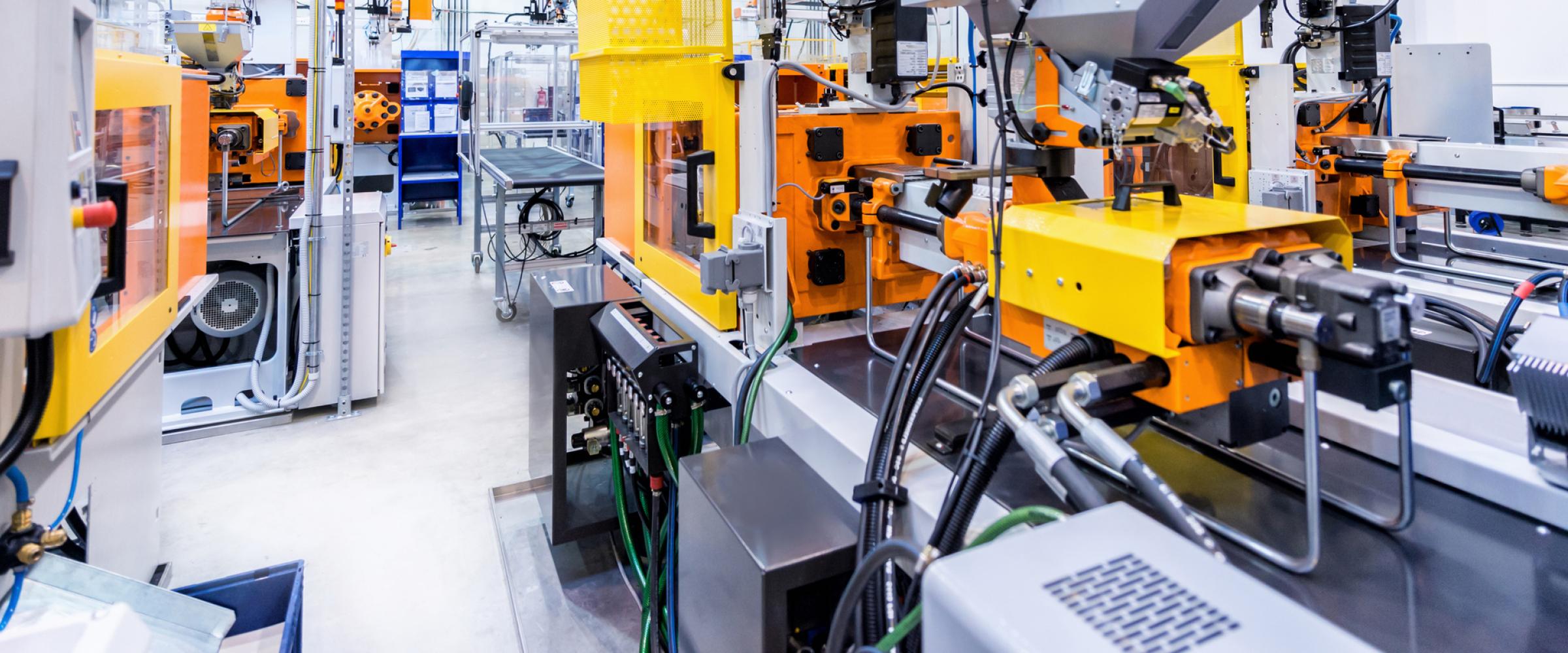 Interior view of an energy management laboratory with yellow and grey machinery.