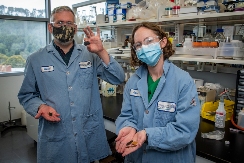 Two scientists hold samples of PDK plastics.
