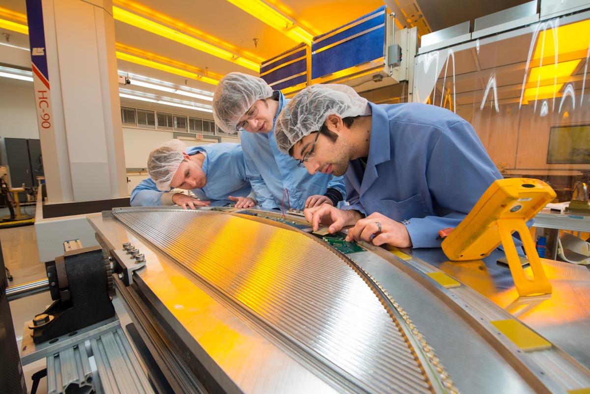 Three scientists working on an experiment.