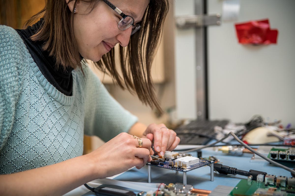 Scientists testing microchips at a bench top.