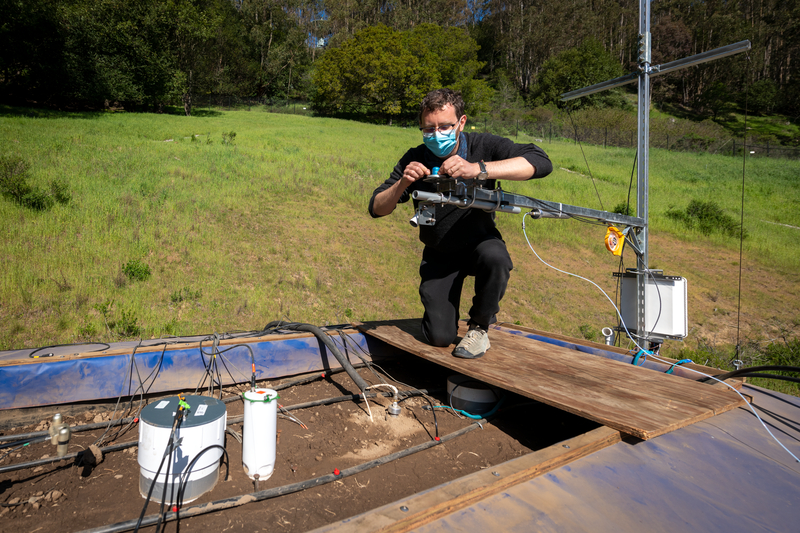 Scientist makes adjustments on the SmartSoils testbed.