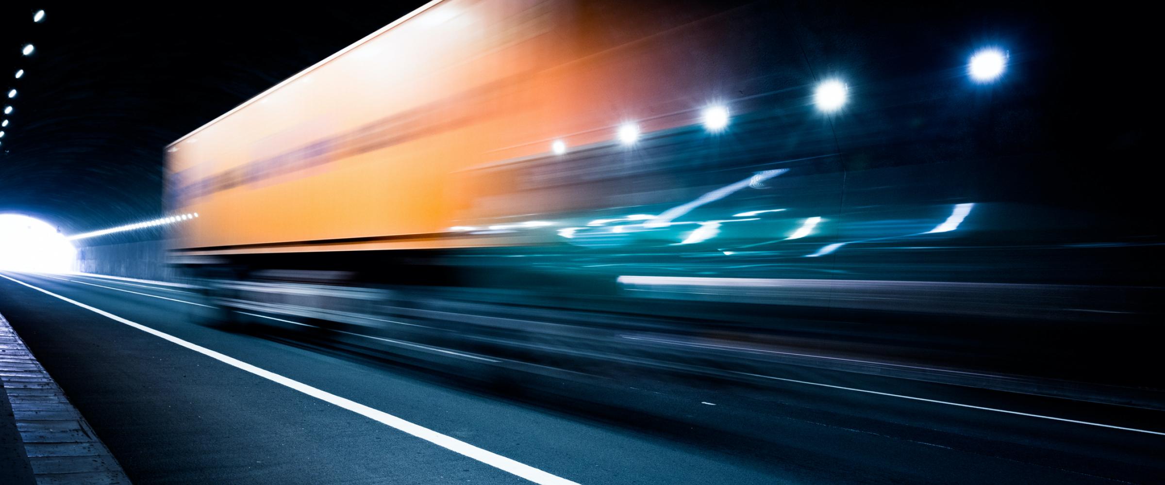 Blurred blue and orange lights in a tunnel.