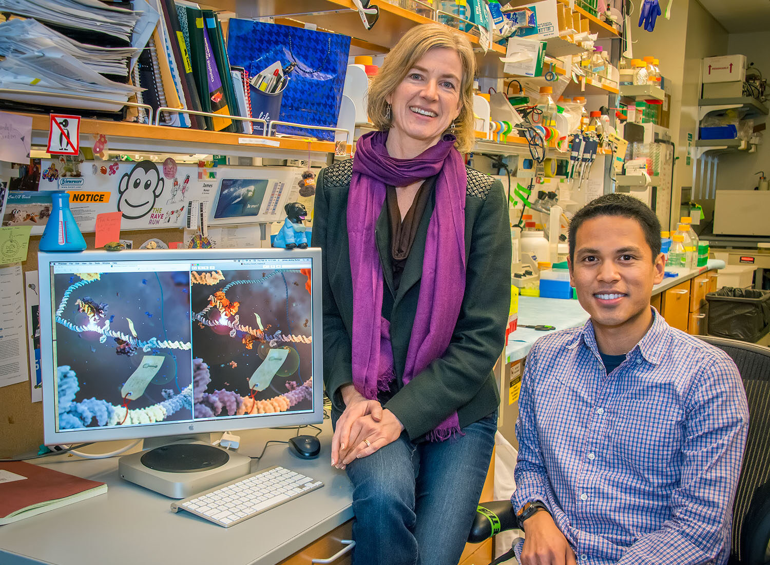 Jennifer Doudna and James Nunez sitting by a computer screen.