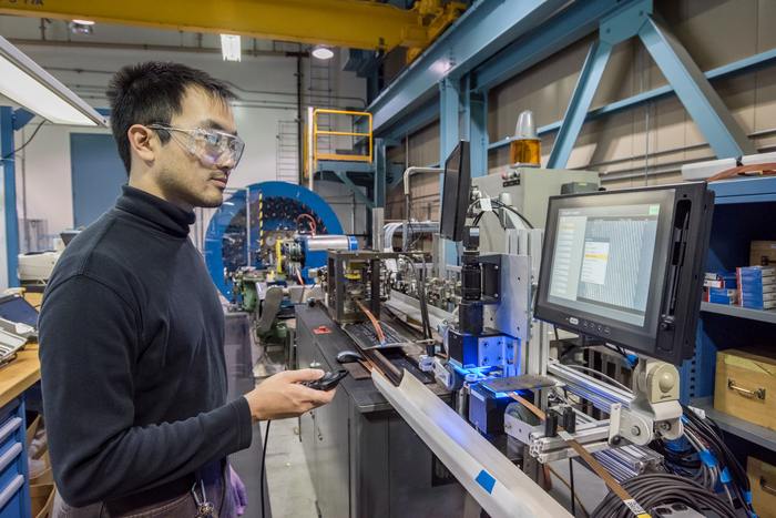 Scientist working on a cabling machine.