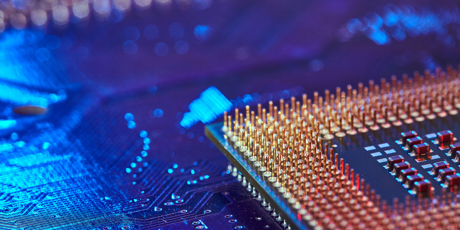 CPU desktop with the contacts facing up lying on the motherboard of the PC. the chip is highlighted with blue light. Technology background