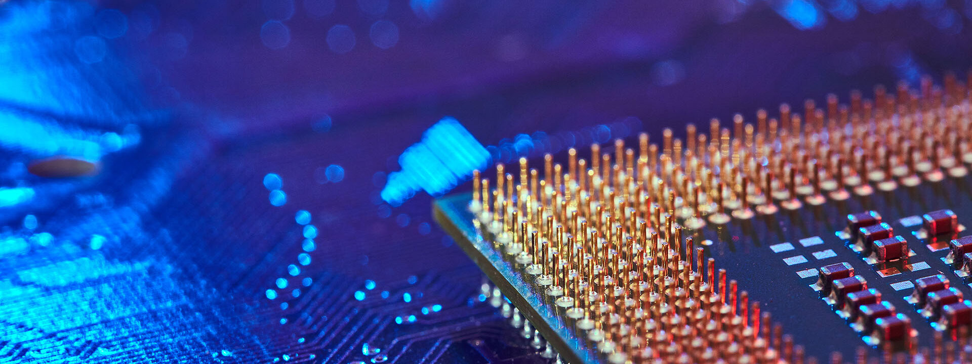 CPU desktop with the contacts facing up lying on the motherboard of the PC. the chip is highlighted with blue light. Technology background