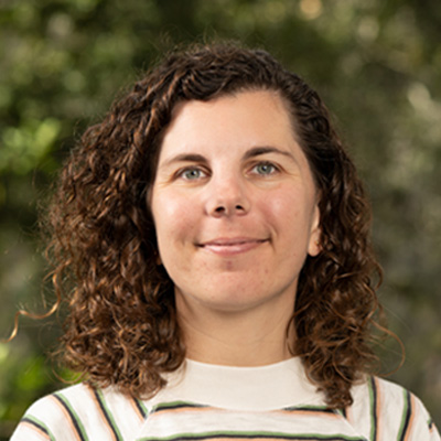 Brown-haired person wearing a white striped shirt.