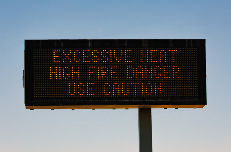 Digital traffic sign reading Excessive Heat High Fire Danger Use Caution.
