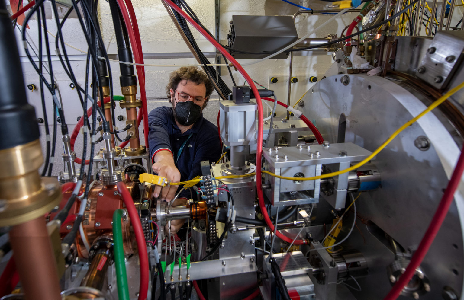 A scientist works on a high repetition-rate electron scattering apparatus in the lab.
