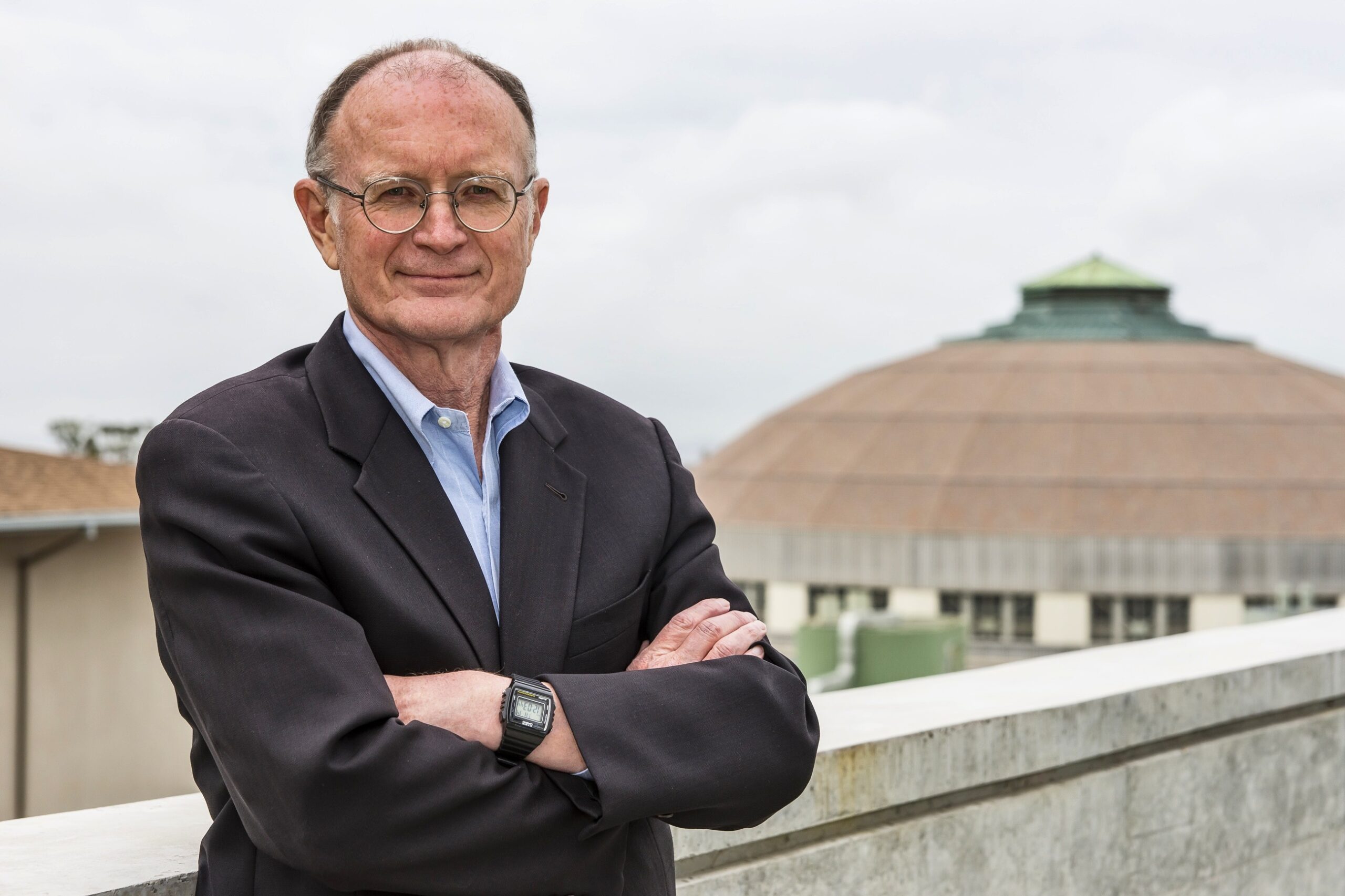 Man in suit standing in front of the Advanced Light Source.