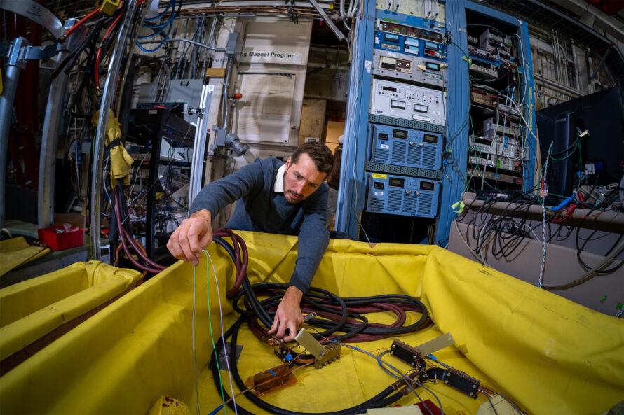 Research scientist Reed Teyber works on a device he developed for measuring high-temperature superconducting magnets.