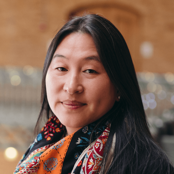 Ting Xu, a person with medium-length black hair wearing a dark top with a colorful scarf, photographed in the Hearst Memorial Mining Building.