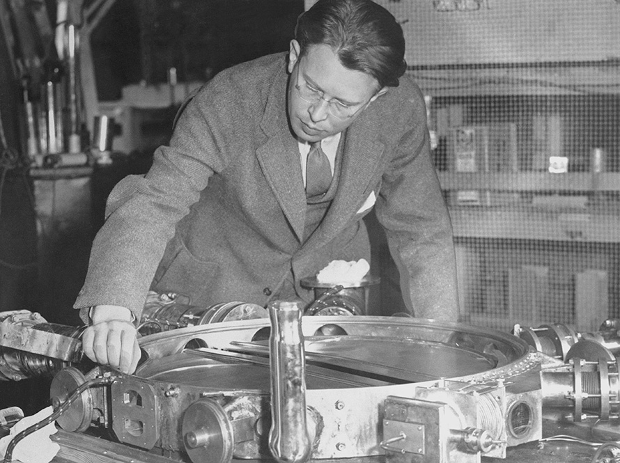 Ernest O. Lawrence examining 37-1/2 inch vacuum chamber with the lid removed.