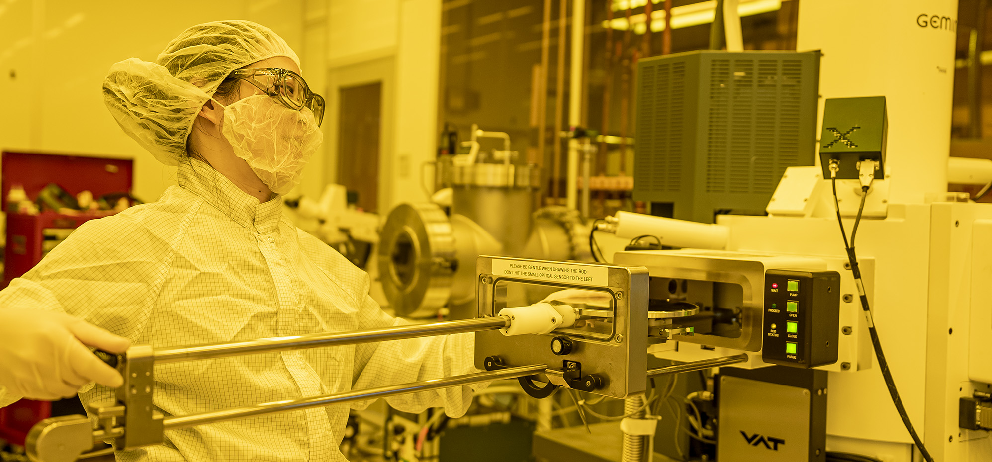 Scientist conducting experiments in a bunny clean room suit.