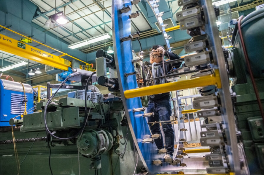Scientist working on a cabling machine.