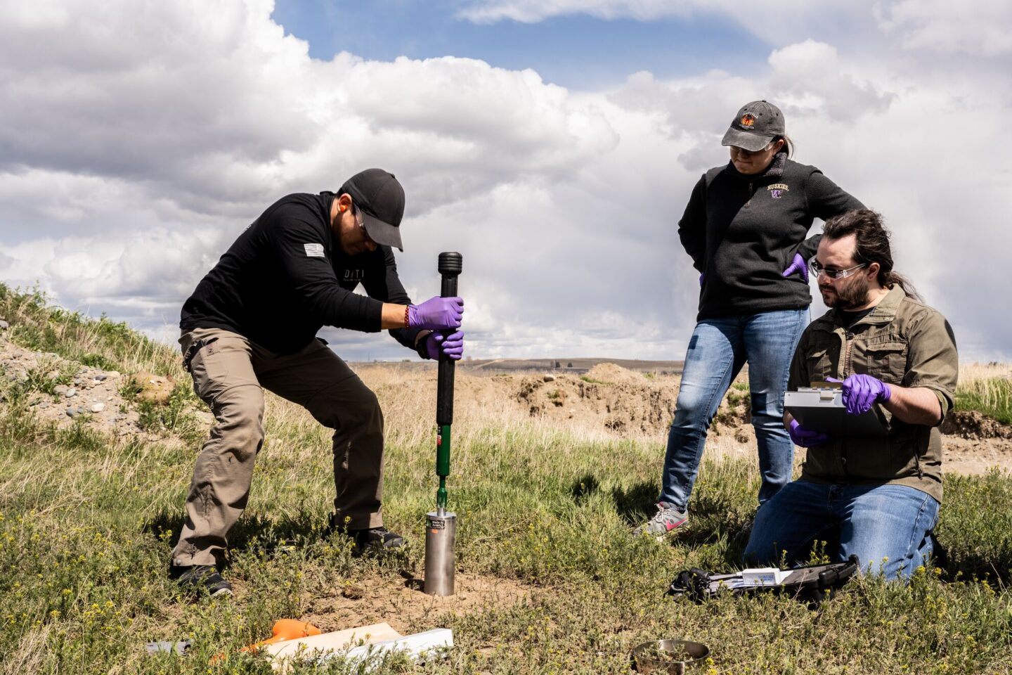 Group of three people excavating for an ESNet upgrade.