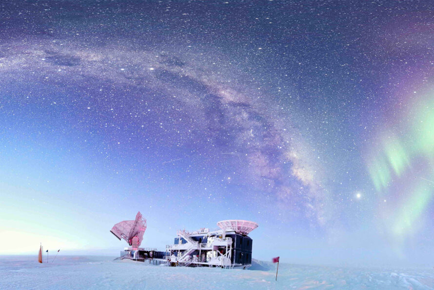 A field site on a snowy field. The sky is illuminated with stars and aurora borealis.