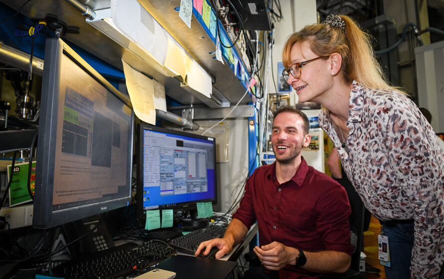 Carolin Sutter-Fella (standing), Staff Scientist, and Tim Kodalle, Postdoctoral Researcher, discuss their research at the Advanced Light Source (ALS).