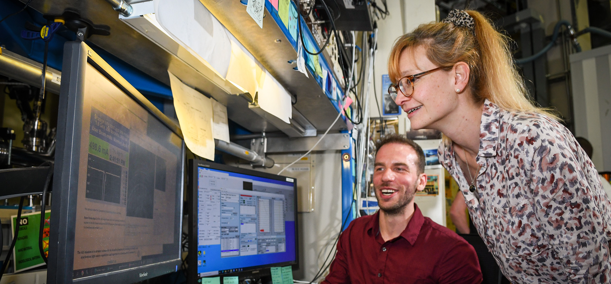 Carolin Sutter-Fella (standing), Staff Scientist, and Tim Kodalle, Postdoctoral Researcher, discuss their research at the Advanced Light Source (ALS).