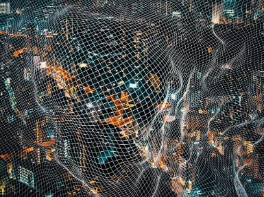 Aerial view of a densely populated city at night, illuminated with orange and white lights, overlaid with a complex mesh network pattern.