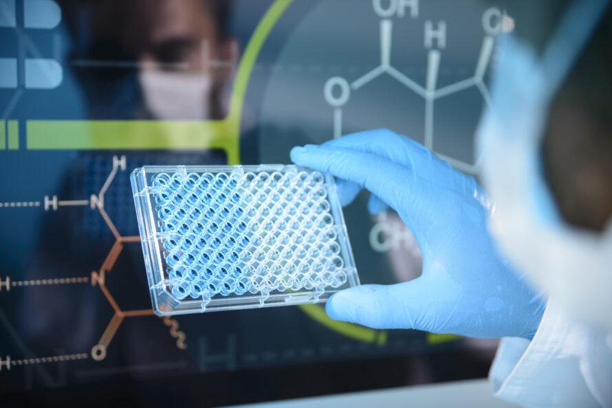 Scientist holding a microtiter plate with digital chemical structures in the background.