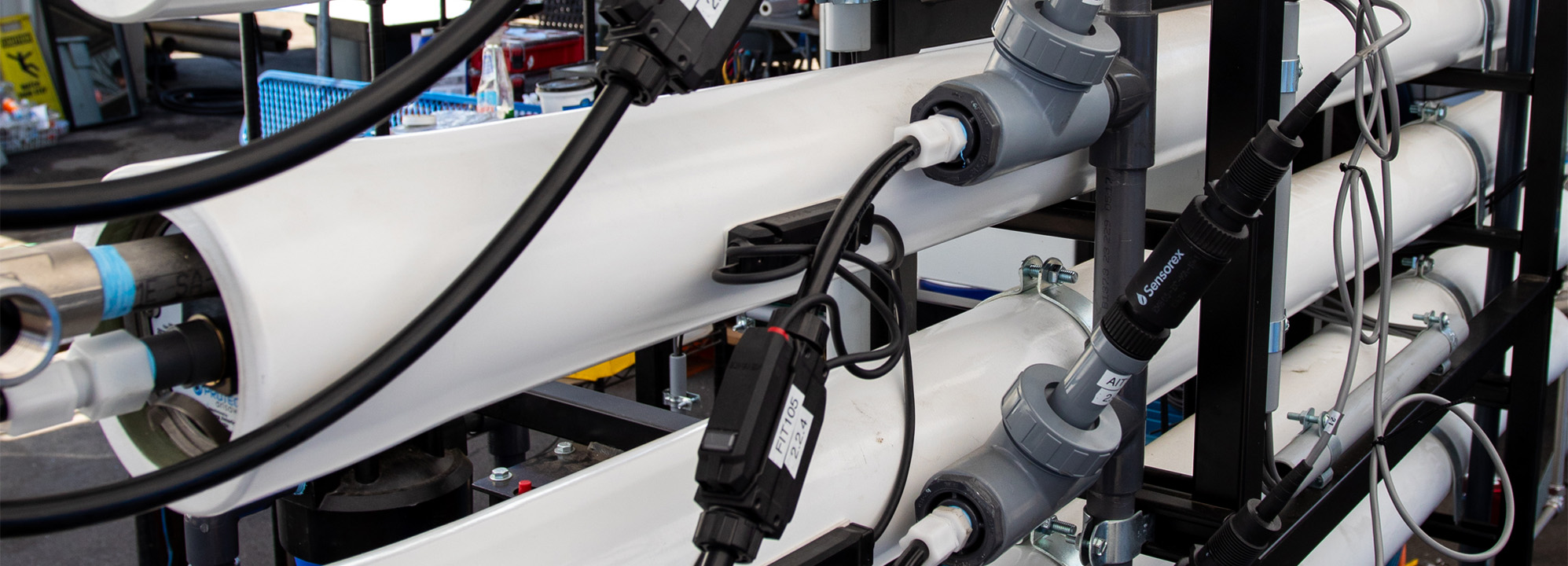 White pipes with various tubes and wires.