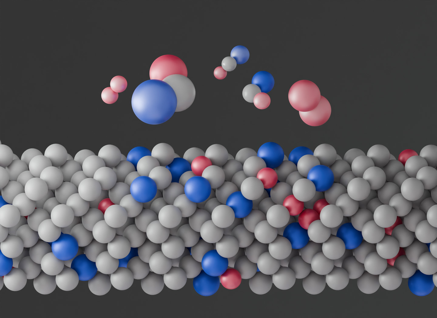 An illustration showing a layer of closely packed spheres, mostly gray, with a few blue and red ones mixed in. Floating above the layer are several small clusters of spheres in different arrangements of the blue, red, and gray.