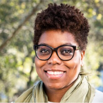 Person wearing glasses and light green scarf