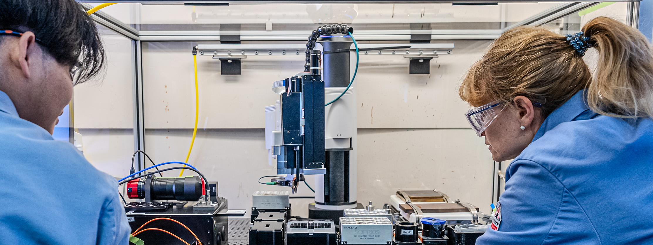 Two researchers operate an autonomous robot.