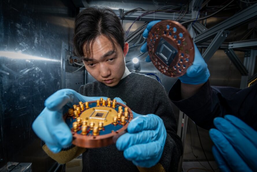 Researcher in blue gloves inspects a Sample Box.