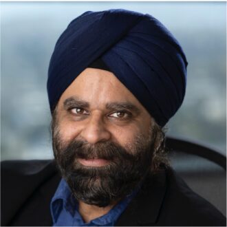 Person with dark hair and a blue turban sitting