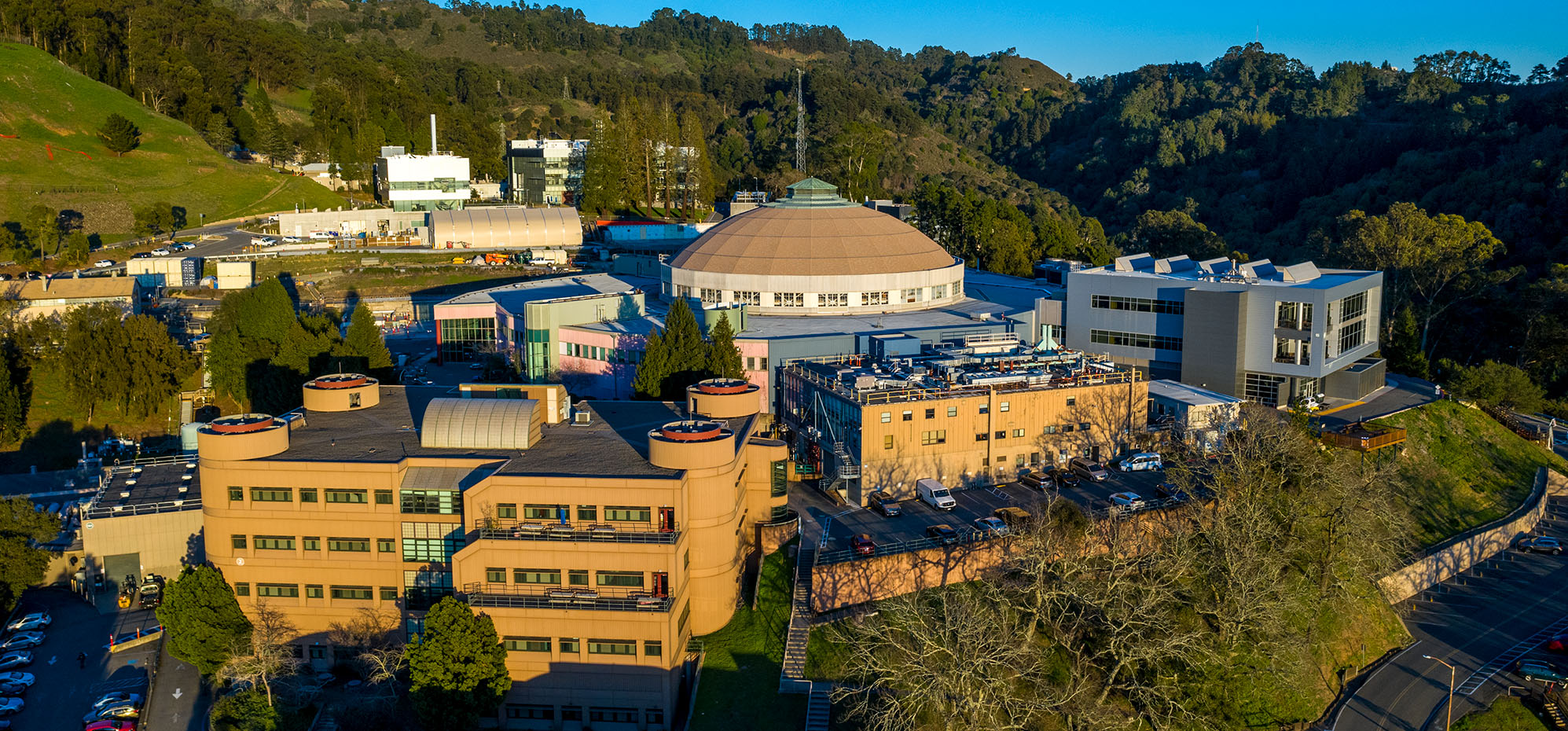 The Advanced Light Source and other buildings on a green hillside.